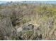 Aerial shot of the house in the trees showing seclusion and a private, wooded setting at 101 Bevil Ridge Se Rd, Emerson, GA 30137
