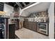 Basement bar area with stainless steel appliances, dark cabinetry, and beverage refrigerators at 101 Bevil Ridge Se Rd, Emerson, GA 30137