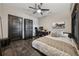 Bedroom features a bed, workspace, ceiling fan, and dark trim around the windows and door at 101 Bevil Ridge Se Rd, Emerson, GA 30137