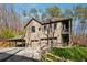 Home exterior featuring a spacious three-car garage, covered carport, and beautiful landscaping at 101 Bevil Ridge Se Rd, Emerson, GA 30137