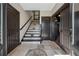 Welcoming foyer with tiled floors, stylish staircase, dark wood doors and natural light at 101 Bevil Ridge Se Rd, Emerson, GA 30137