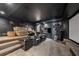 Home theater room with tiered seating, projector screen, dark walls and movie-themed decorations at 101 Bevil Ridge Se Rd, Emerson, GA 30137