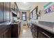 Well-equipped laundry room with dark cabinetry, granite countertops, and a window for natural light at 101 Bevil Ridge Se Rd, Emerson, GA 30137