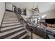 Open-concept living room with a stone fireplace, high ceilings, and staircase to the second floor at 101 Bevil Ridge Se Rd, Emerson, GA 30137