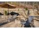 Relaxing patio area with lounge chairs, fire pit, and brick retaining wall, perfect for outdoor entertaining at 101 Bevil Ridge Se Rd, Emerson, GA 30137