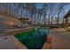 Inviting pool area with lounge seating and lush landscaping, perfect for outdoor relaxation and entertainment at 101 Bevil Ridge Se Rd, Emerson, GA 30137