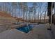 Beautiful outdoor pool area with stone patio, lounge chairs, and professional landscaping at 101 Bevil Ridge Se Rd, Emerson, GA 30137