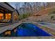 Backyard featuring a refreshing pool and spa, surrounded by stone walls and lush landscaping at 101 Bevil Ridge Se Rd, Emerson, GA 30137