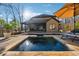 Inviting pool area with stone patio, lounge chairs, and umbrella, perfect for relaxing by the backyard of the home at 101 Bevil Ridge Se Rd, Emerson, GA 30137