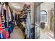 Spacious walk-in closet with custom shelving for clothes and shoes, plus an attached tiled shower room at 101 Bevil Ridge Se Rd, Emerson, GA 30137