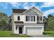 Charming two-story home featuring a painted brick facade, black shutters, and a two-car garage at 1355 Elowen Dr, Austell, GA 30168