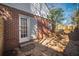 Cozy brick home features a backyard with stone pavers and a white back door at 1475 Elizabeth Ln, East Point, GA 30344