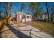 Charming brick home featuring a cozy front porch and well-maintained lawn with a concrete driveway at 1475 Elizabeth Ln, East Point, GA 30344