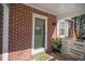 Charming home features a welcoming front porch with potted plants and a decorative welcome mat at 1475 Elizabeth Ln, East Point, GA 30344
