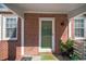 Cozy front porch with brick detail, plants, and a 'Welcome' mat at 1475 Elizabeth Ln, East Point, GA 30344