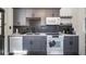 Well-appointed kitchen with gray cabinets, white countertops, and modern appliances at 1475 Elizabeth Ln, East Point, GA 30344