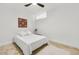 Bright bedroom featuring a white bed, ceiling fan, white walls and travertine tile flooring at 198 Ponce De Leon Ne Ave # 2A, Atlanta, GA 30308