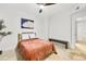 Bright bedroom featuring a plush bed, ceiling fan, white walls and travertine tile flooring at 198 Ponce De Leon Ne Ave # 2A, Atlanta, GA 30308