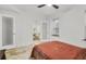 Bright bedroom featuring a plush bed, ceiling fan, and travertine tile flooring near the dining area at 198 Ponce De Leon Ne Ave # 2A, Atlanta, GA 30308