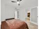 Bright bedroom featuring a plush bed, ceiling fan, white walls and travertine tile flooring near the kitchen at 198 Ponce De Leon Ne Ave # 2A, Atlanta, GA 30308