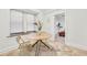 Bright dining area featuring a round table, modern chairs, and travertine tile floors near a bedroom at 198 Ponce De Leon Ne Ave # 2A, Atlanta, GA 30308