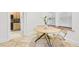 Bright dining area featuring a round table, modern chairs, and travertine tile floors near an open kitchen at 198 Ponce De Leon Ne Ave # 2A, Atlanta, GA 30308