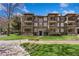 View of a stately brick apartment building with multiple stories, charming balconies, and manicured lawns at 198 Ponce De Leon Ne Ave # 2A, Atlanta, GA 30308