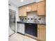 Functional kitchen featuring stainless steel appliances, sleek black countertops, and warm-toned wooden cabinetry at 198 Ponce De Leon Ne Ave # 2A, Atlanta, GA 30308