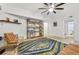 Bright living room with tile floors, a comfortable armchair, stylish shelving, and a contemporary ceiling fan at 198 Ponce De Leon Ne Ave # 2A, Atlanta, GA 30308