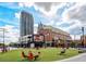 Lively town square with a mix of commercial buildings, green space, outdoor seating, and pedestrian activity at 198 Ponce De Leon Ne Ave # 2A, Atlanta, GA 30308
