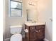 Cozy bathroom features a dark wood vanity and ample lighting at 12142 Panhandle Rd, Hampton, GA 30228
