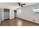 This bedroom boasts two closets, wood flooring, and two windows at 12142 Panhandle Rd, Hampton, GA 30228
