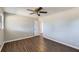 This bedroom boasts wood flooring, a ceiling fan, and large window at 12142 Panhandle Rd, Hampton, GA 30228