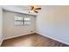 This bedroom has wood flooring, a ceiling fan, and a window at 12142 Panhandle Rd, Hampton, GA 30228