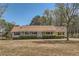 Ranch style home with a long porch and mature trees at 12142 Panhandle Rd, Hampton, GA 30228