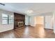 Bright living room features a brick fireplace and wood-look flooring at 12142 Panhandle Rd, Hampton, GA 30228