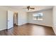 Spacious main bedroom with wood flooring, ceiling fan, and a large window at 12142 Panhandle Rd, Hampton, GA 30228