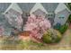 Townhome backyard with blooming pink tree, bushes, and small patio at 2275 W Village Se Ln, Smyrna, GA 30080