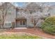 Townhome with small patio and privacy fence surrounded by landscaping at 2275 W Village Se Ln, Smyrna, GA 30080
