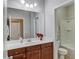 Bathroom featuring a large mirror and vanity, with toilet and tub/shower combo visible at 2275 W Village Se Ln, Smyrna, GA 30080