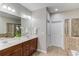 Bathroom with double sink vanity, tile floors, soaking tub, and glass shower at 2275 W Village Se Ln, Smyrna, GA 30080