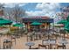 Outdoor seating area at Starbucks cafe with tables and umbrellas under cloudy skies at 2275 W Village Se Ln, Smyrna, GA 30080