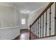Hallway features hardwood floors, staircase, and wainscoting at 2275 W Village Se Ln, Smyrna, GA 30080