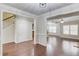 Open-concept living room with hardwood floors and staircase entrance at 2275 W Village Se Ln, Smyrna, GA 30080