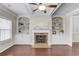 Bright living room featuring a fireplace, built-in shelves, and hardwood floors at 2275 W Village Se Ln, Smyrna, GA 30080