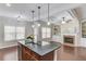 Open living space with a kitchen island, ample cabinets, and fireplace at 2275 W Village Se Ln, Smyrna, GA 30080