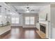 Open living space with a kitchen, fireplace, hardwood floors, and modern lighting at 2275 W Village Se Ln, Smyrna, GA 30080