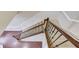 Staircase featuring dark wood handrail and iron spindles, leading to the carpeted upper level at 2275 W Village Se Ln, Smyrna, GA 30080