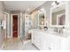 Bright bathroom with a glass enclosed shower, double sink vanity, and marble floors at 1580 Commerce Dr # A8, Decatur, GA 30030