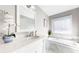 Bright bathroom featuring a soaking tub with jets, undermount sink, and white cabinetry at 1580 Commerce Dr # A8, Decatur, GA 30030